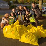 group of young people with trash bags